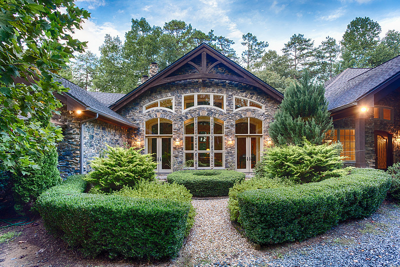 Front exterior of a mountain home with stone accents and landscaped entry, real estate photography in North Georgia