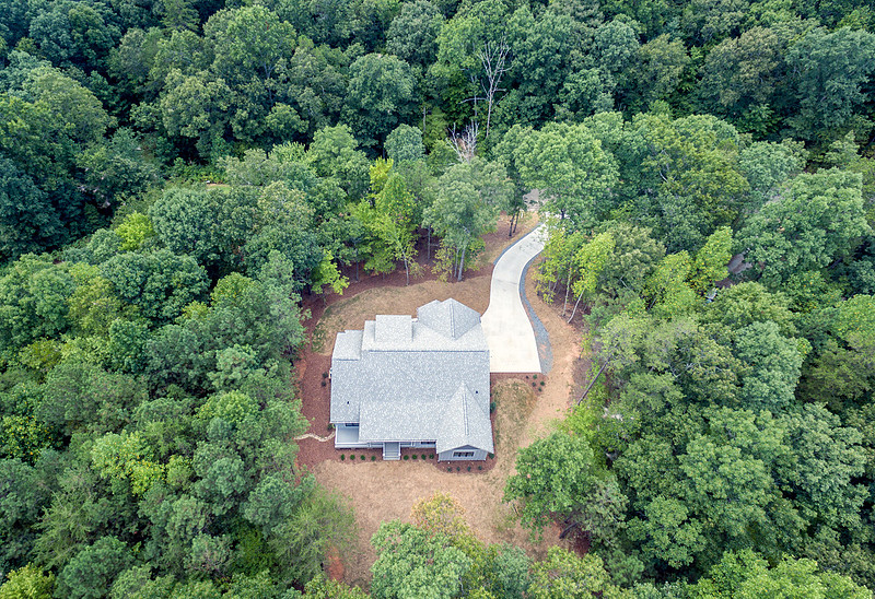 Aerial drone view of a home site surrounded by forest, real estate photography in North Georgia