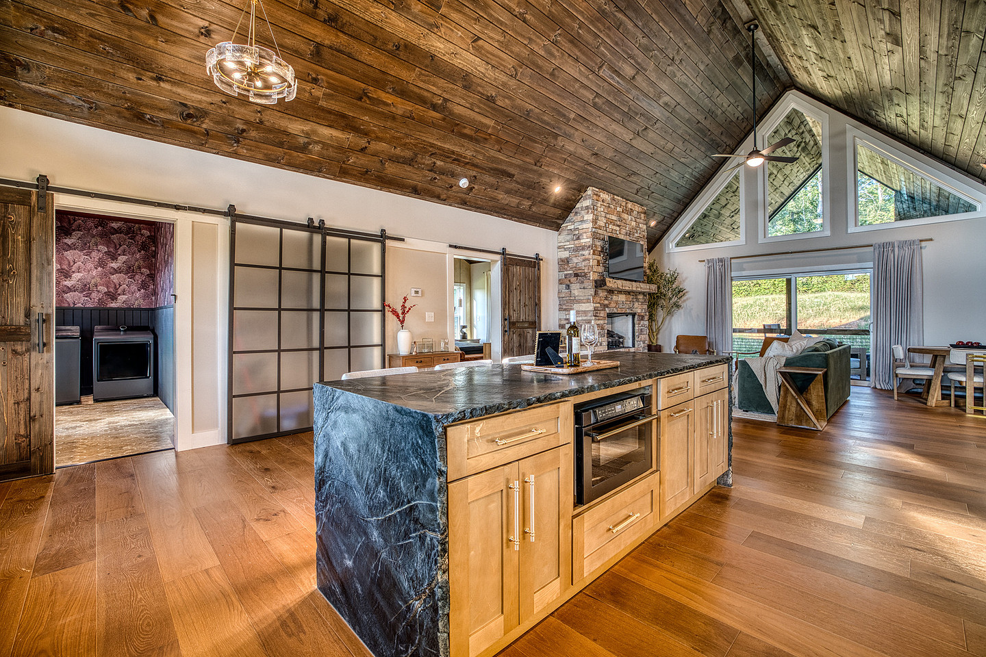 Open kitchen with island and wood beams