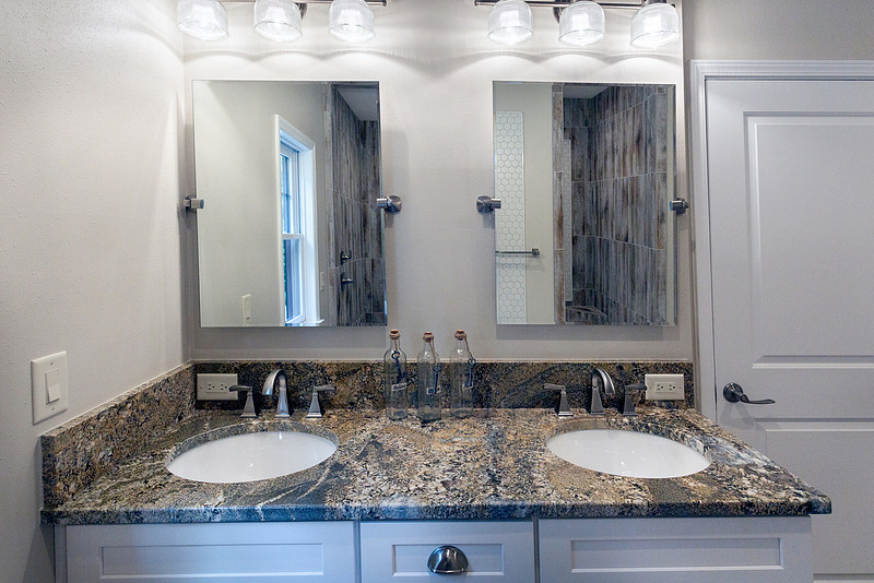 Bathroom with a double vanity and granite counters, real estate photography in North Georgia
