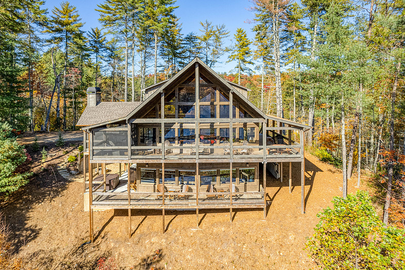 Rear exterior of a mountain cabin with multi-level decks, real estate photography in North Georgia