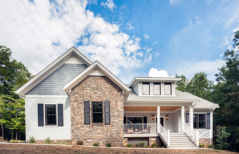 Front exterior of a stone and siding farmhouse with a covered porch, real estate photography in North Georgia
