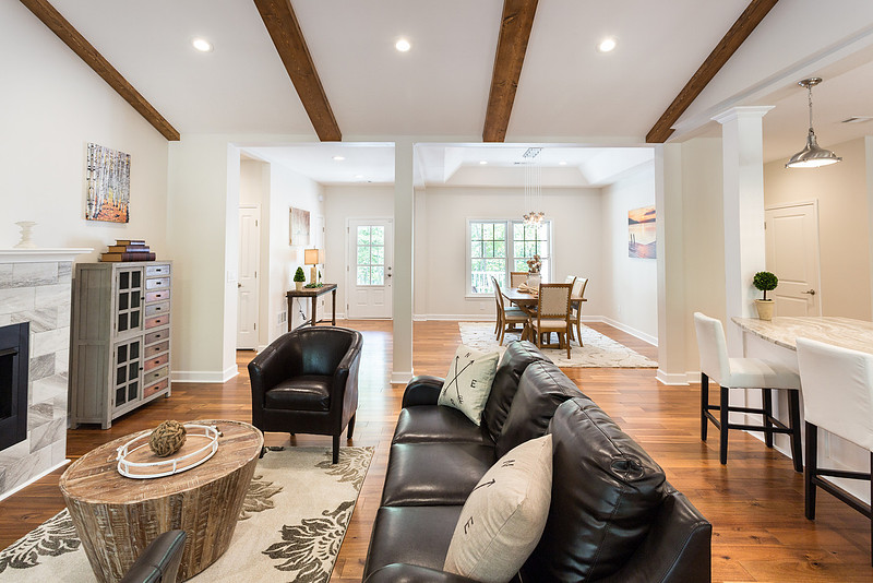 Open-plan living room with exposed beams, real estate photography in North Georgia