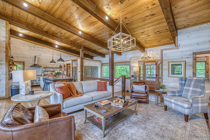 Living room of a cabin with a vaulted wood ceiling, real estate photography in North Georgia