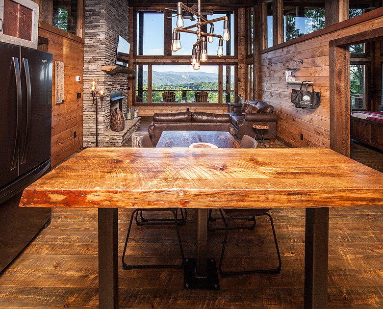 Rustic dining room with a live-edge table and mountain view windows, real estate photography in North Georgia