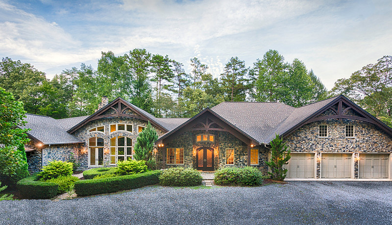 Front exterior of a stone and cedar craftsman ranch home, real estate photography in North Georgia